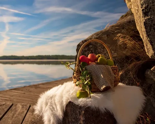 Apples in basket by the lake